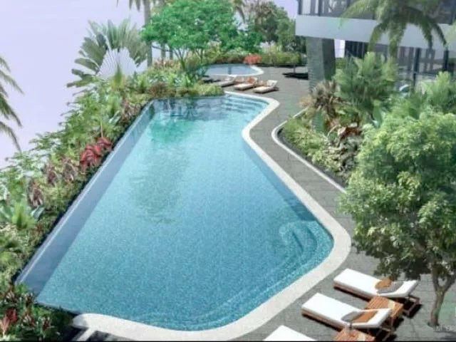 Swimming pool surrounded by tropical planting